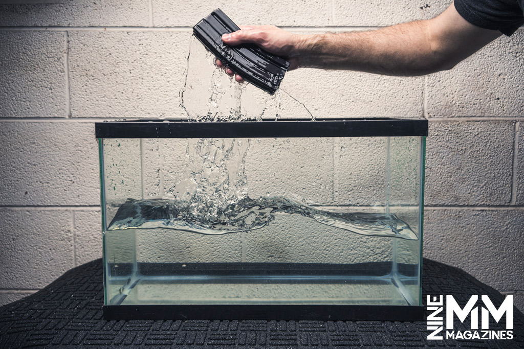 a man gun magazine testing by submerging a magazine in water
