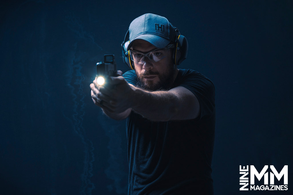 a photo of a man shooting a glock handgun