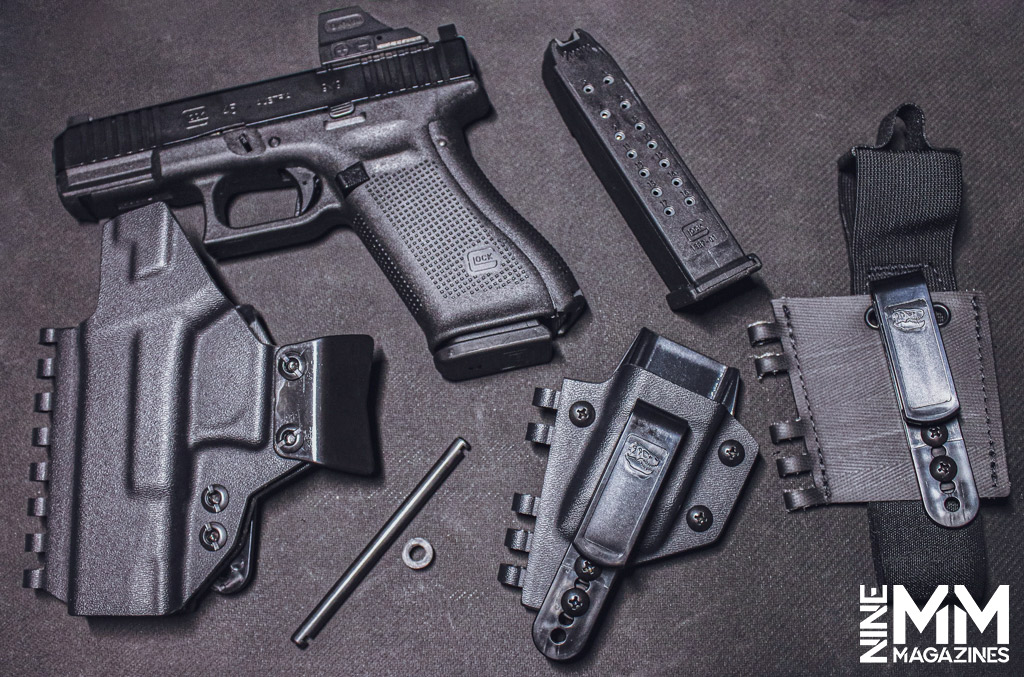 a photo of a glock 45 handgun with holster and accessories