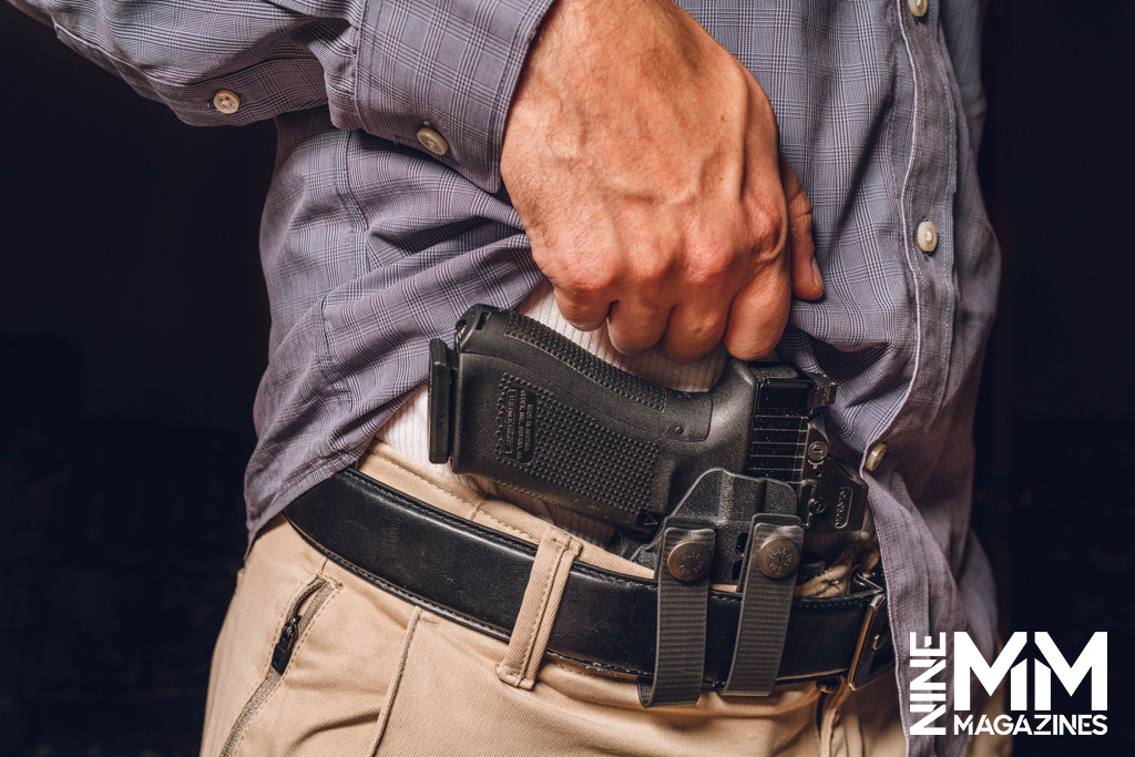 a photo of a man concealed carrying a glock handgun
