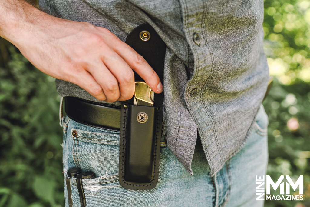 a photo of a knife in a leather belt sheath