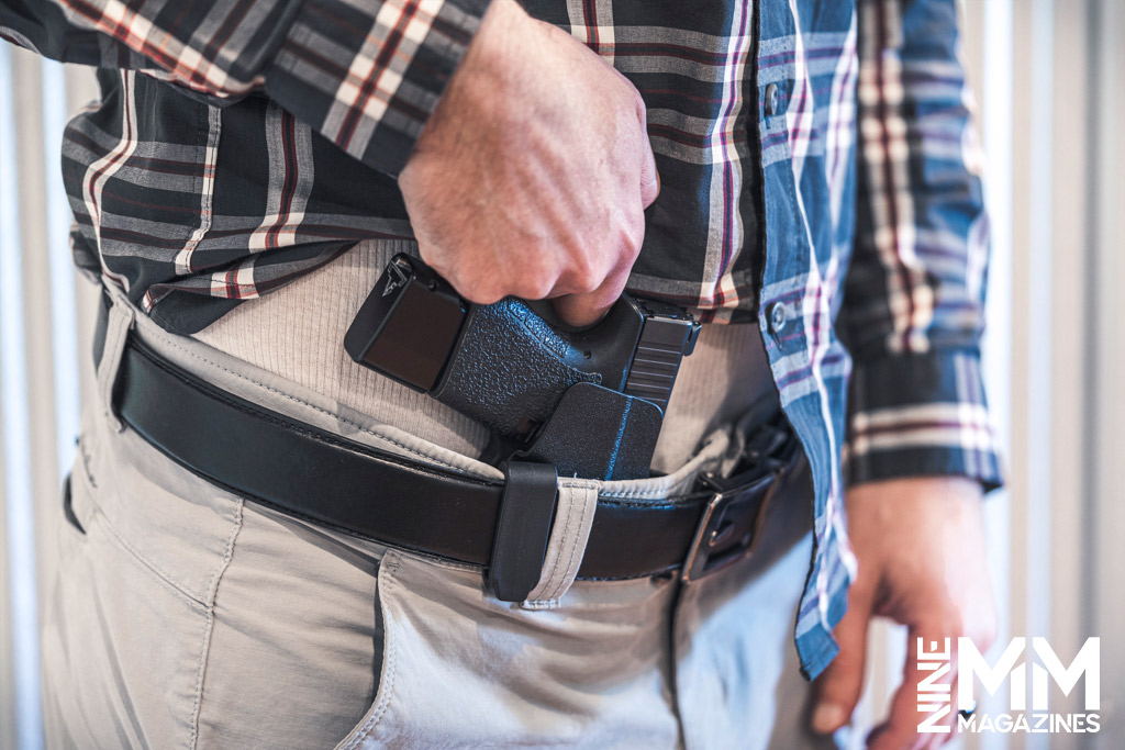 a photo of a man concealed carrying a Glock handgun
