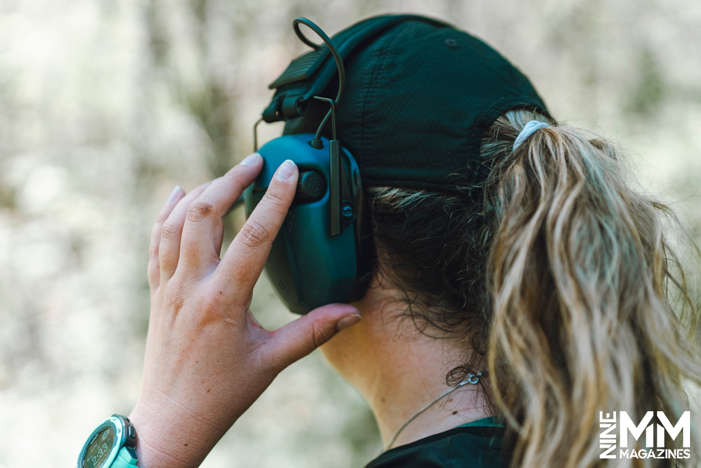 a photo of a woman wearing Savior Equipment Apollo Electronic Earmuffs