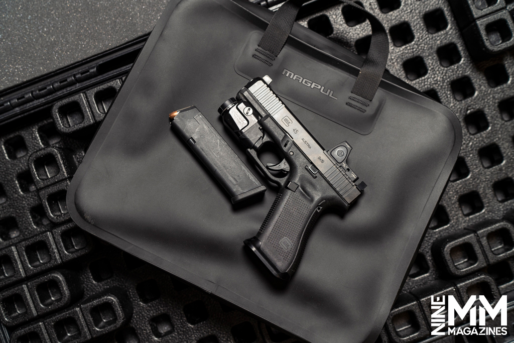 a photo of a glock handgun on a pistol case