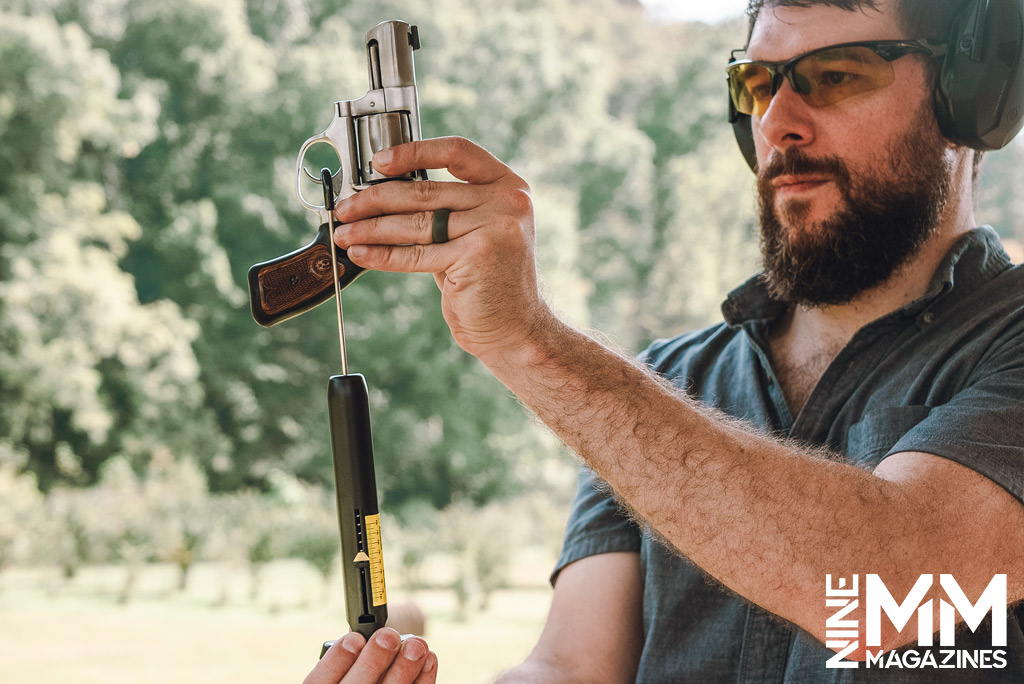 a photo of a man using a wheeler trigger pull scale