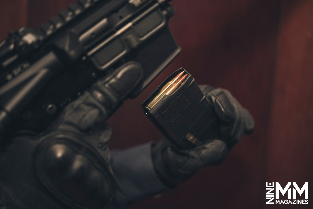 a hand inserting a rifle magazine a photo of a hand inserting a rifle magazine
