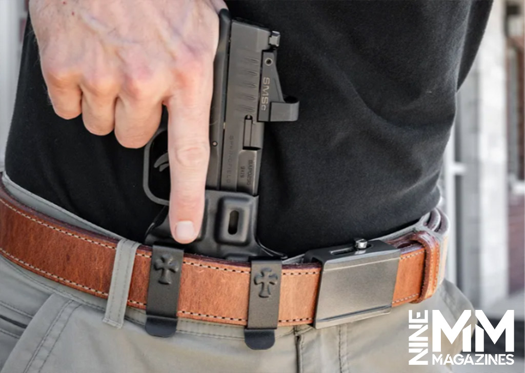 photo of a man drawing a gun from a holster