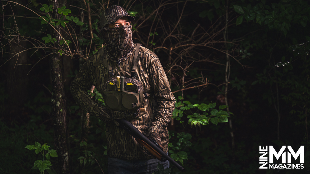 a photo of a man hunting turkeys in the woods