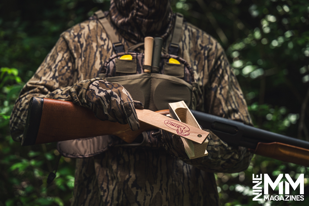a photo of a turkey hunter in the woods