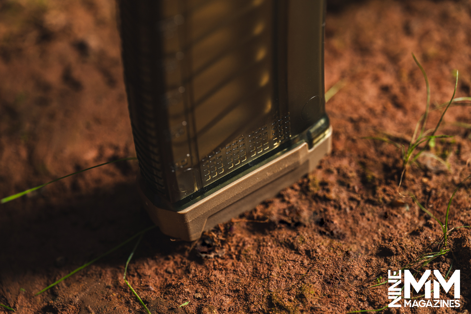 a photo of a rifle magazine in the dirt
