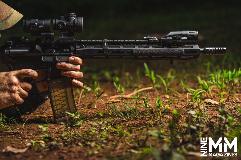 a photo of a man shooting a rooting tooting ar-15 rifle
